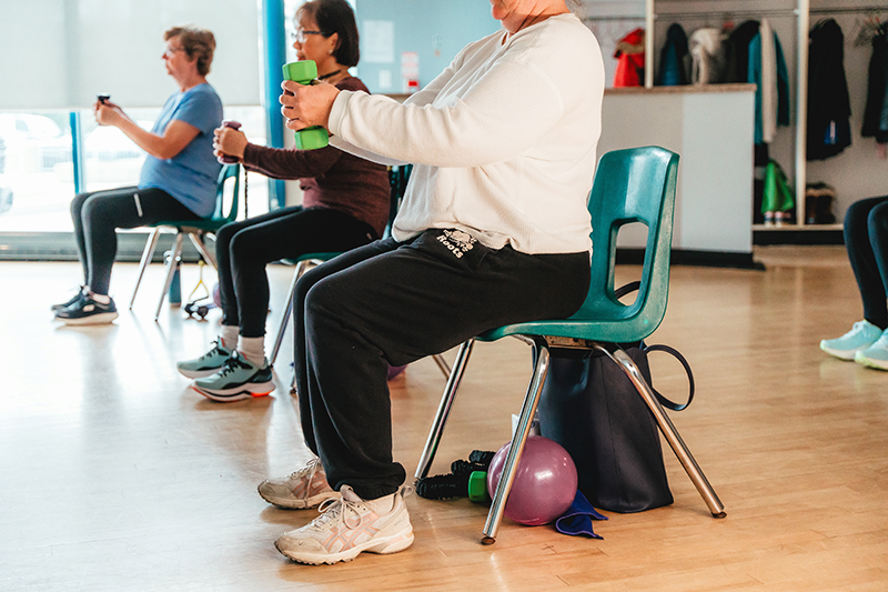 a chair fitness class with people using free weights
